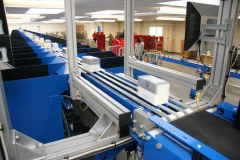 Packets get transported on an incline belt conveyor to the pop-up sortation system